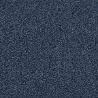 Navy blue fabric sample with dense granular texture, uneven surface, and subtle tonal variations, potentially for upholstery.