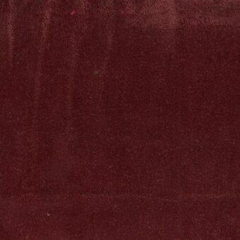 Burgundy fabric texture with a short plush pile, displaying tonal variations and a granular surface; Ditre Italia Post 089 material.