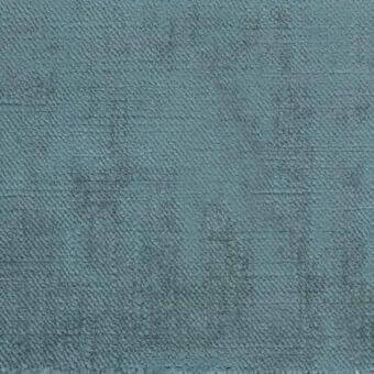Teal textured fabric sample with a dense grid pattern of raised circles, horizontal striations, and a raw edge; Ditre Italia trend 035.