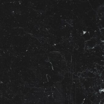 Nero Marquina marble texture displaying black stone with dense white veining, organic patterns, polished finish, and subtle light reflection.