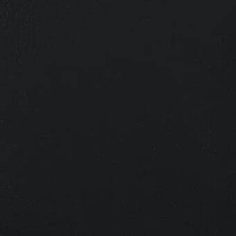 Black matte texture, granular surface, uniform darkness, close-up view of a solid, dark-colored material with subtle tonal variations.