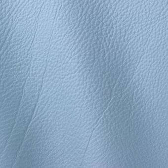 Light blue leather texture with a granular, pebble grain pattern, displaying matte finish and subtle tonal variations across a smooth surface.