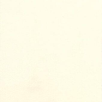 Off-white paper sheet with matte texture, uneven edges, and subtle color variations creating a diffused, neutral composition.