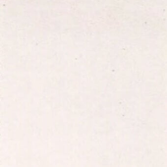 Pale blush fabric swatch with subtle texture, featuring scattered dark speckles and a matte finish, resembling linen or raw cotton fibers.