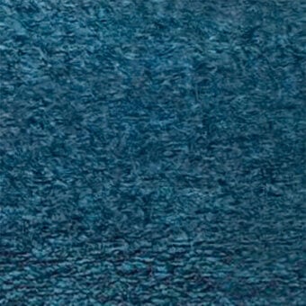 Teal velvet fabric texture with irregular ripples, displaying a plush surface and subtle sheen; “egoitaliano” brand detail visible.
