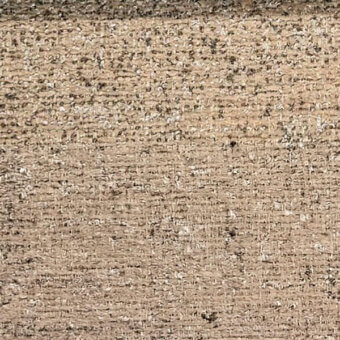 Beige woven fabric texture with vertical ribbing, mottled tones, and dark flecks; tight, coarse weave with oily sheen, labeled “egoitaliano.”