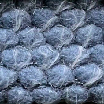 Textured plastic material, grayish-blue “puffo” color, displays rounded cellular forms with translucent, fibrous surface and irregular crinkled pattern.