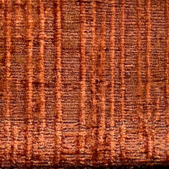 Reddish-brown woven fabric texture with vertical stripes, a rough granular surface, and mottled tonal variations; “egoitaliano > fabric (d) > marlys” text.