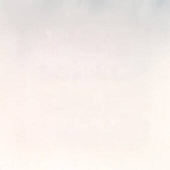 Gradient sky with pale pink and light blue-gray tones, diffused atmospheric haze, and a smooth, blended color transition throughout the composition.