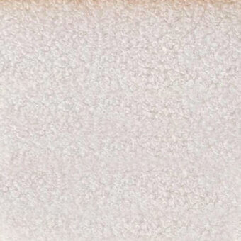 Microfiber textile sample, light beige with mottled texture, displaying “egoitaliano > microfibra > naixe” text imprint on a matte surface.