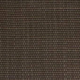 Woven fabric texture, earthy brown with vertical ribs, dense matte finish, heathered effect, manufacturer detail visible upper left.