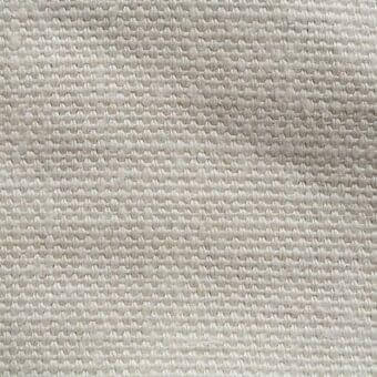 Stone-washed linen fabric texture, light beige and gray tones, dense woven structure with horizontal and vertical threads, matte finish.