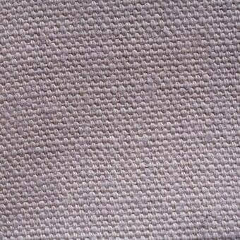 Stone-washed linen fabric sample, grayish-taupe tone, dense weave with subtle texture and irregular yarn pattern; label reads "erba lino 010".