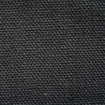 Dark gray stone-washed fabric texture with a dense, nubby weave and consistent knotted pattern against a neutral background.