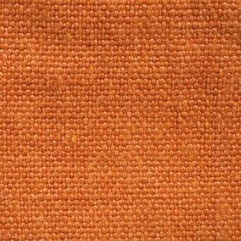 Stone-washed linen fabric sample, warm arancio color, dense weave with horizontal and vertical threads forming a grid pattern.