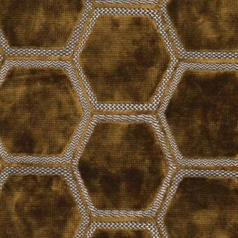 Ochre manipur fabric with repeating hexagonal motifs outlined in braided beige and white yarn, displaying a textured, mottled surface.