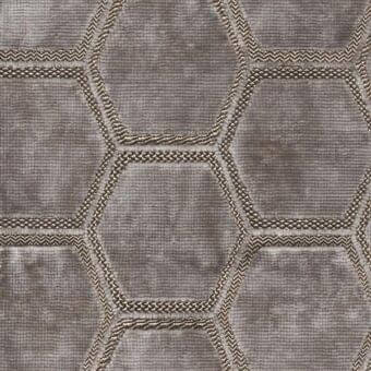 Dove gray textile sample with repeating hexagonal pattern, featuring textured fabric and zigzag trim edges, mottled finish.