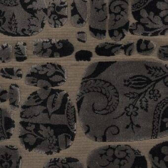 Beige velvet fabric swatch, “le pas des anges” collection, with dark gray medallions featuring stylized foliage and a dense, ornate design.