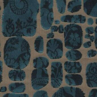 Textile sample, “le pas des anges” fabric in etoupe, displays repeating teal oval shapes with dense floral damask patterns and a plush texture.