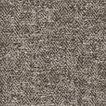 Neutral woven fabric sample displaying a granular texture with gray, beige, and brown mottled tones and embedded pebble-like elements.