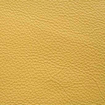 Yellow leather texture with a granular, pebbled surface and matte finish, displaying a warm, muted carioca tone and natural, tactile quality.