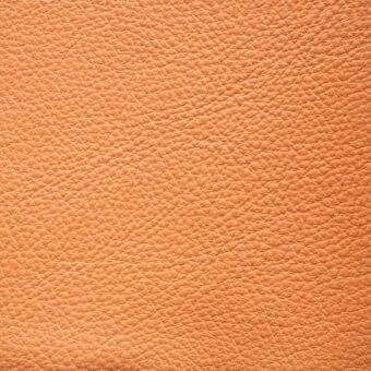 Tanned leather texture, sunset boulevard color, densely pebbled grain with subtle tonal variations and a smooth, slightly reflective finish.