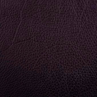 Dark brown leather texture with repeating geometric pattern, displaying a matte finish and subtle tonal variations for depth.