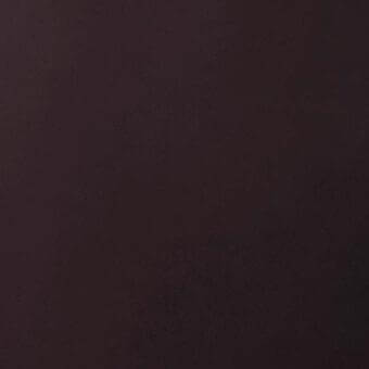 Dark reddish-brown leather swatch displays a smooth, tight weave texture with even illumination and a saturated burgundy tone.