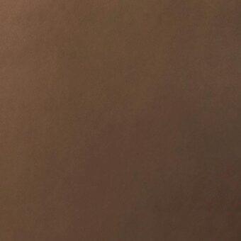 Brown leather texture sample with a matte finish and granular surface, displaying warm tonal variations and a dense, natural weave.