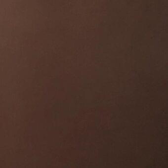 Brown leather texture sample with matte finish, gradient tone, and fine grain, indicating full-grain quality and understated luxury.