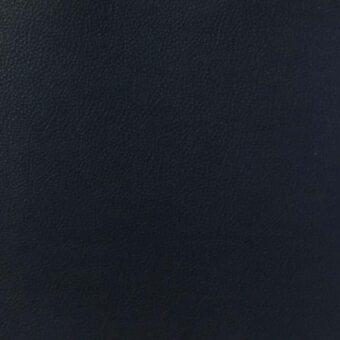 Black leather texture with a mottled surface and fine creases against a dark background, displaying a matte finish and dense grain.