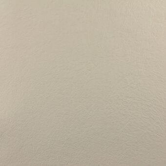 Leather swatch pale beige fine-grained texture matte finish sample marking white background natural material detail closeup.