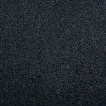 Saddle nero leather texture displaying a dense, granular surface with consistent dark gray-black coloration and a subtle, mottled pore pattern.
