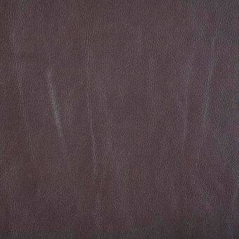 Saddle tobacco leather texture displaying a dark brown hue, vertical striations, and a matte finish with subtle creases and natural grain.