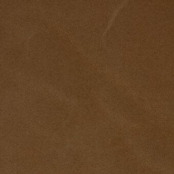 Stonewash senape leather texture displaying a matte, earthy brown finish with irregular grain and subtle distressed markings.
