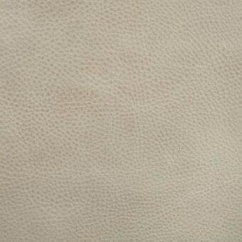 Leather texture sample, light beige, granular pumice grain with irregular lines and matte finish, suitable for upholstery applications.