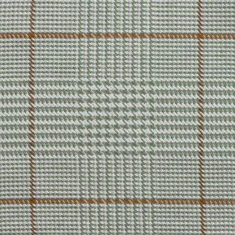 Green and white plaid textile with rust-orange grid lines, dense woven squares, matte finish; “formitalia” text visible.