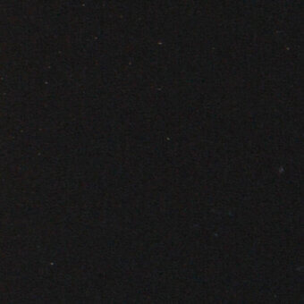 Fenix black material texture with granular matte finish, scattered yellow dots, brand name visible, diffuse lighting.
