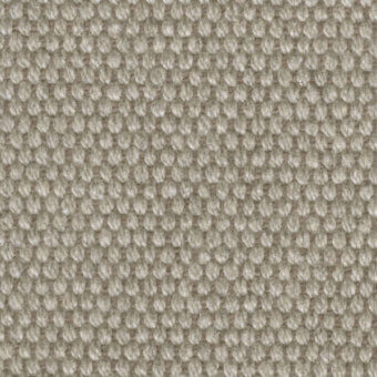 Beige woven fabric texture displaying a dense grid of raised circles, with subtle tonal variations and a nubby, irregular surface.