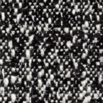 Woven fabric texture, black and off-white fibers, speckled pattern with a nubby, irregular surface and dynamic visual composition.
