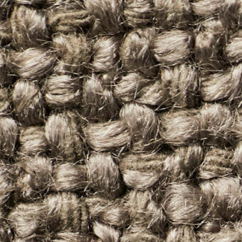 Coarse jute fabric texture, muted marigold color, dense nubby weave with rounded knots and tonal variations, natural fiber textile sample.