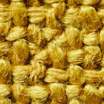 Jute fabric texture, warm marigold color, dense woven strands with nubby surface and visible fiber variations; sample labeled “marigold 08137 804”.
