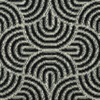 Geometric textile pattern in black and cream tones features concentric teardrops and elongated diamonds, woven with a textured, slightly raised surface.
