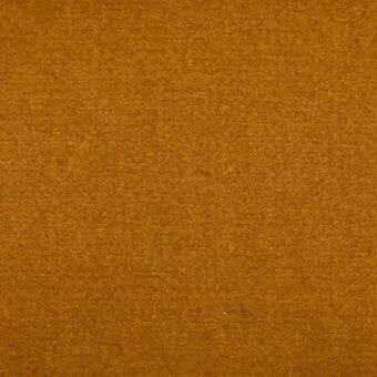 Mustard yellow velvet fabric texture with a dense, short pile and matte finish, displaying subtle surface variations and visible fibers.