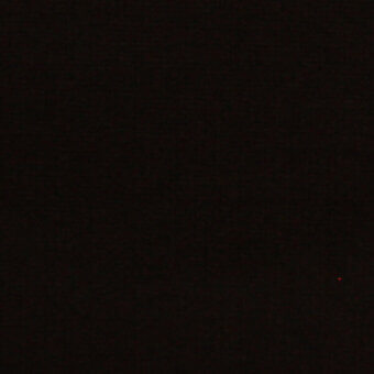 Dark granular texture with a small red light point, faint white text “horm > outdoor flukso clouds ambience > 516 ambience” visible in low light.