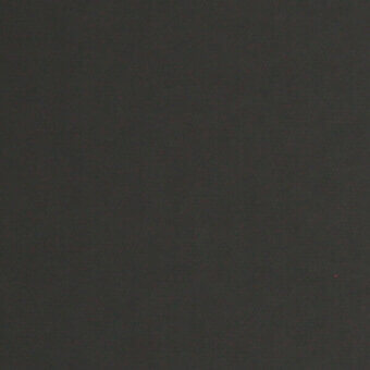Dark brown textured surface with subtle tonal variations, even lighting, and a small red speck in the lower right corner.