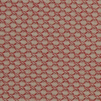Coral-red textile sample features a grid of circular perforations woven into a light beige fabric, with product text visible along the edge.