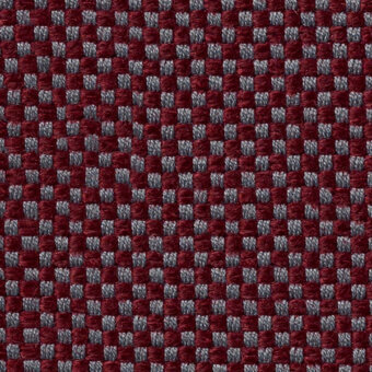 Burgundy woven textile features a gray checkerboard grid pattern, displaying a raised, structured surface with “horm > vescom samar” text.