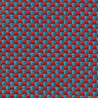 Red and teal checkerboard textile sample with a dense weave, coarse texture, and grid-like pattern; Vescom Samar 7052 45.