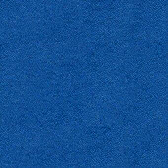 Blue fabric texture displaying a granular, matte finish with a densely packed, particulate surface and uniform solid color appearance.